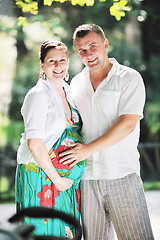 Image showing Happy pregnant couple at beautiful sunny day in park