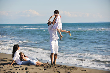 Image showing happy young  family have fun on beach