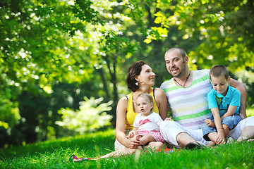 Image showing happy young couple with their children have fun at park