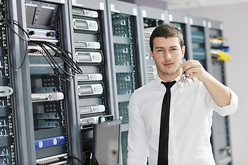 Image showing young it engeneer in datacenter server room