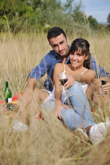Image showing happy couple enjoying countryside picnic in long grass