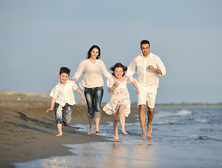 Image showing happy young family have fun on beach at sunset