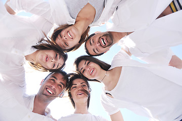 Image showing Group of happy young people in circle at beach