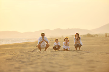 Image showing happy young family have fun on beach at sunset