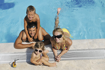 Image showing happy young family have fun on swimming pool