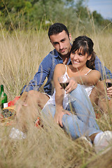 Image showing happy couple enjoying countryside picnic in long grass