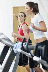 Image showing woman workout  in fitness club on running track 