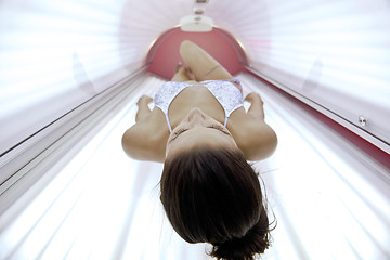 Image showing Beautiful young woman tanning in solarium