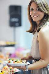 Image showing womanl chooses tasty meal in buffet at hotel