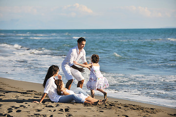 Image showing happy young  family have fun on beach