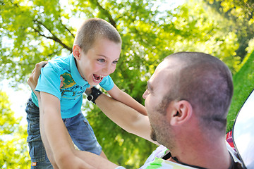 Image showing happy father and son have fun at park