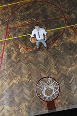 Image showing businessman holding basketball ball