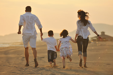 Image showing happy young family have fun on beach at sunset