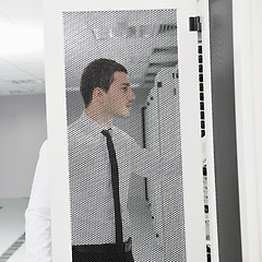 Image showing young it engeneer in datacenter server room