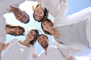 Image showing Group of happy young people in circle at beach