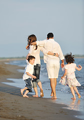 Image showing happy young family have fun on beach at sunset