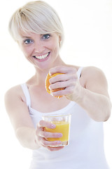 Image showing Young woman squeeze orange juice