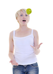 Image showing happy  young  woman eat green apple isolated  on white