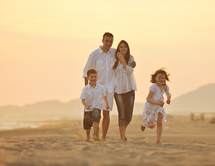 Image showing happy young family have fun on beach at sunset