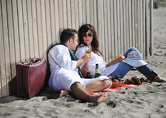 Image showing young couple enjoying  picnic on the beach