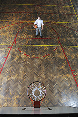 Image showing businessman holding basketball ball