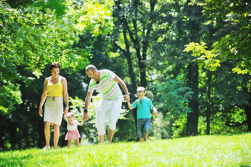 Image showing happy young couple with their children have fun at park