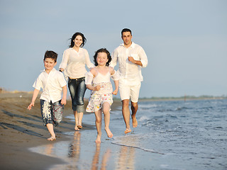 Image showing happy young family have fun on beach at sunset