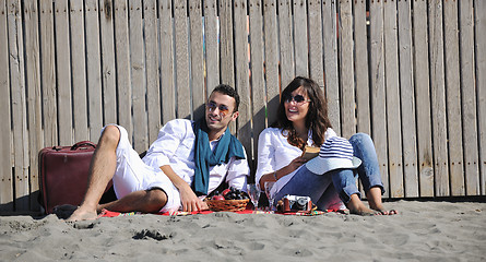 Image showing young couple enjoying  picnic on the beach