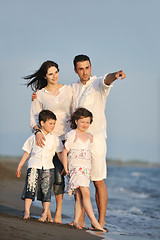 Image showing happy young family have fun on beach at sunset