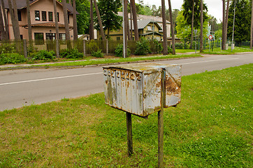 Image showing Old rusty mailboxes retro wooden houses district 