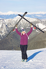 Image showing Girl with skis in mountains
