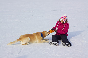 Image showing Girl on ice skates with dog