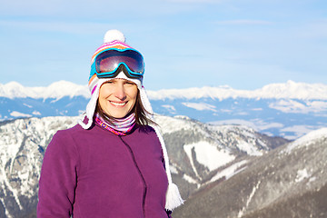 Image showing Smiling girl in snowy mountains