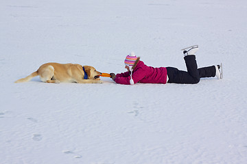 Image showing Girl playing with dog