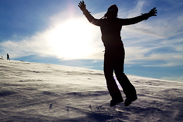 Image showing Girl jumping in snow