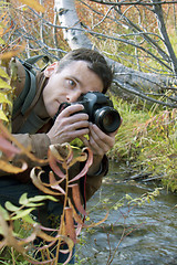 Image showing Man was inclined over a stream 
