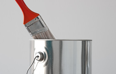 Image showing Paint bucket and red paintbrush