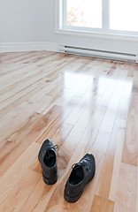 Image showing Shoes entering an empty room full of light