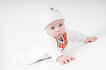 Image showing Baby in snowman costume lying on the floor