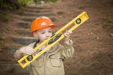 Image showing Adorable Child Boy with Level Playing Handyman Outside