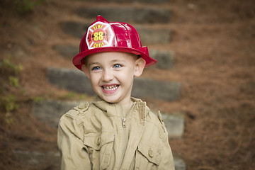 Image showing Adorable Child Boy with Fireman Hat Playing Outside