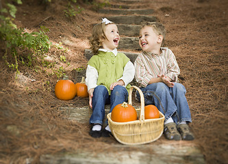 Image showing Brother and Sister Children Sitting on Wood Steps with Pumpkins