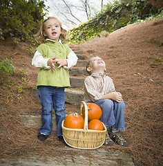 Image showing Brother and Sister Children on Wood Steps with Pumpkins Singing