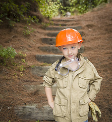 Image showing Adorable Child Boy with Big Gloves Playing Handyman Outside