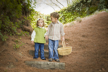 Image showing Two Children Walking Down Wood Steps with Basket Outside.