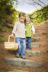 Image showing Two Children Walking Down Wood Steps with Basket Outside.