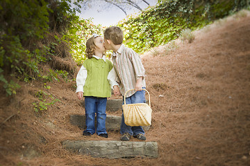 Image showing Two Children with Basket Kissing Outside on Steps