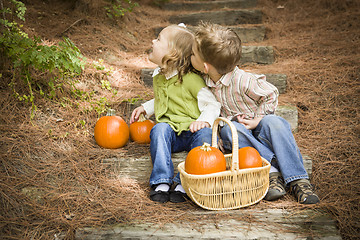 Image showing Brother and Sister Children on Wood Steps with Pumpkins Playing