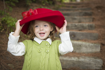 Image showing Adorable Child Girl with Red Hat Playing Outside