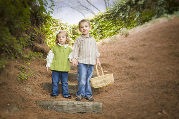 Image showing Two Children Walking Down Wood Steps with Basket Outside.